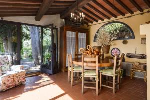 a dining room with a wooden table and chairs at Il Palazzaccio - Tuscan Historical Villa in Reggello in Reggello