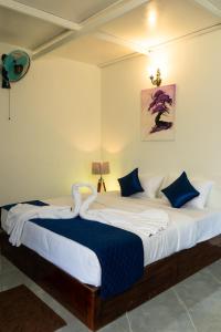 a bedroom with a large bed with a swan on it at Coorg Saturn Homes in Madikeri