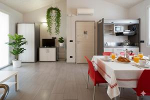 a kitchen and dining room with a table and red chairs at Il Sole Di Bruno in Imperia