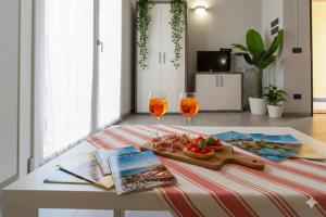 two glasses of wine and a tray of food on a table at Il Sole Di Bruno in Imperia +2 photos