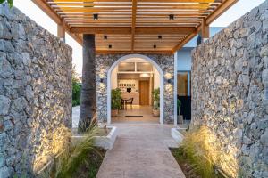 an entrance to a home with a stone wall at Cirillo Family Hotel-Christinas Studios in Mastichari +73 photos