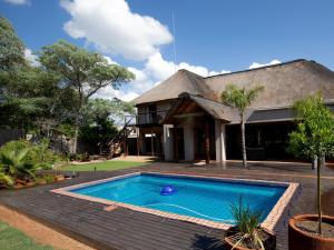 a house with a swimming pool in the yard at Weavers Nest Guesthouse in Modimolle