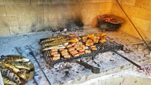 a grill with many different types of food on it at Family-friendly apartments with swimming pool Vinisce, Trogir - 12676 in Vinišće