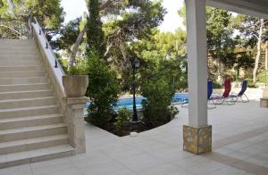 a patio with stairs and chairs and a pool at Seaside house with a swimming pool Hvar - 12919 in Hvar