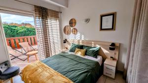 a bedroom with a bed and a balcony at Presqu'île de la Lagune - Piscine - Mer & Nature in Saint-Cyprien