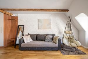 a living room with a couch and a hammock at Old Town Gem - Rooftop Studio - By Innorental in Rīga