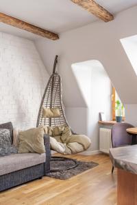 a living room with a couch and a white brick wall at Old Town Gem - Rooftop Studio - By Innorental in Rīga