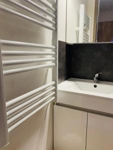 a bathroom with white cabinets and a sink at Le petit soleil in Lamalou-les-Bains +8 photos