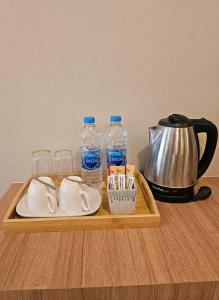 a wooden tray with two bottles of water and glasses at la la lay beach house in Tab Kaek Beach