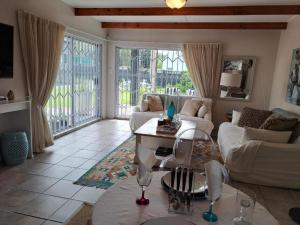 a living room with a couch and a table at Milky Way in Hermanus