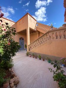 a building with a staircase with plants and flowers at Nomadic Birdway in Imiter
