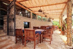 a restaurant with wooden tables and chairs and a brick wall at Apartments by the sea Hvar - 10430 in Hvar