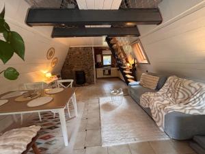 a living room with a couch and a table at Cozy Tiny House am Ferienpark in Plötzky