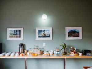 a counter with cups and other items on it at Harewood Lodge in East London +16 photos