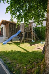 a playground in a yard with a slide at Apartments with parking space Lipovaca, Plitvice - 17657 in Rakovica