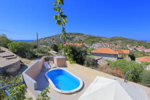a swimming pool in the backyard of a house at Holiday house with a swimming pool Razanj, Rogoznica - 17904 in Rogoznica