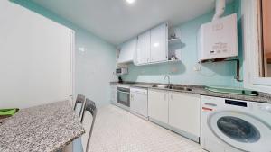 a kitchen with a sink and a washing machine at Casa Cubillas in Teruel