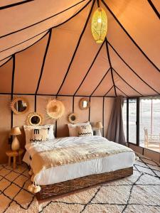 a bedroom with a bed in a tent at Desert cmp luxury in Merzouga