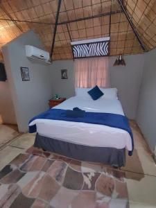 a bedroom with a large bed in a room at Clarky's Pride Lodge in Alldays