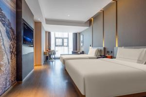 Postel nebo postele na pokoji v ubytování Atour Hotel Xian Bell Tower Yongningli + 34 fotografií