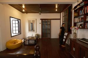 a man is standing in a living room at a-mâze house in Hue