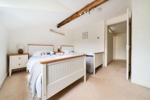 a bedroom with a bed and a sink at Avocet Cottage in Brancaster