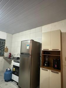 a kitchen with a stainless steel refrigerator and a stove at Aparentemente Bem Localizado in Boa Vista +3 photos