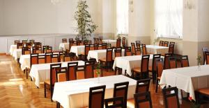 a row of tables and chairs in a room at Sanatorium Borkowo in Połczyn-Zdrój