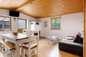 una sala de estar con una mesa y un sofá en Ferienhaus Weichart, en Sulzburg