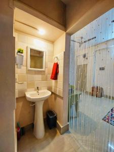 a bathroom with a sink and a shower at The Mishing Room in Guwahati