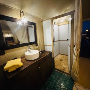 a bathroom with a sink and a shower at Dream Luxury Majestic Camp in Merzouga