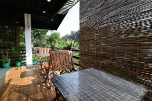 a patio with two chairs and a table and a brick wall at BLK villa-Don's Place - Bliss Lavish Kandy in Kandy