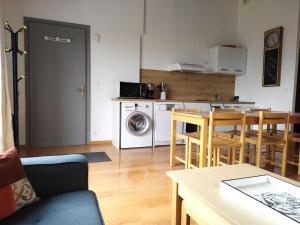 een keuken en woonkamer met een tafel en stoelen bij L'ourmeou in Coursegoules