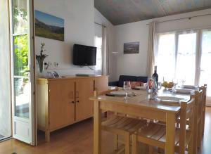een eetkamer met een tafel en een televisie bij L'ourmeou in Coursegoules +39 foto's