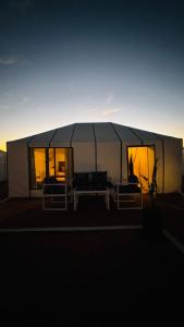 a large white tent with two beds in it at Dream Luxury Majestic Camp in Merzouga