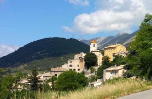 a village on a hill with a church on it at Le cheiron in Coursegoules