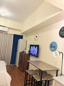 a room with a bed and a table with stools at Arlowes at 20f Grand Residences Cebu in Cebu City