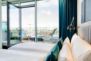 Postel nebo postele na pokoji v ubytování Motel One Karlsruhe