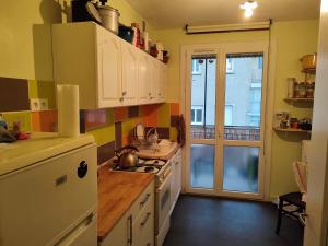 a kitchen with a sink and a stove top oven at Appartement plein centre in Saint-Étienne +9 photos
