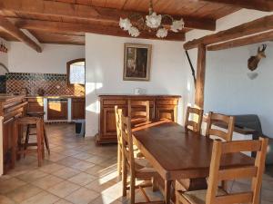 a kitchen with a wooden table and chairs at La bastide du rousset in Ascros