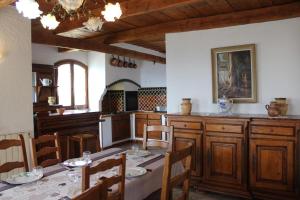 a kitchen with a table and chairs in a room at La bastide du rousset in Ascros