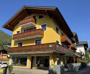 a large yellow building with wooden balconies on it at Au 10 in St. Wolfgang