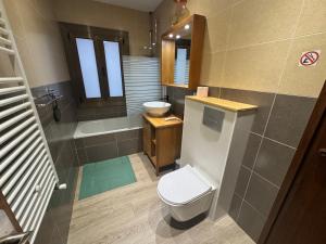 a bathroom with a toilet and a sink and a tub at Immodelpas Mundial in Pas de la Casa +45 photos