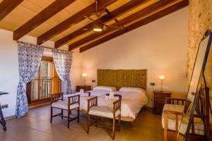 a bedroom with a bed and a table and chairs at Son Pons in Llucmajor