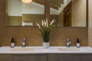 a bathroom with two sinks and a mirror at Son Pons in Llucmajor +37 photos