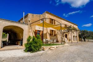 a building with a yellow tent in front of it at Son Pons in Llucmajor