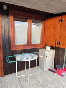 a table in front of a kitchen with a window at La Baita del Sagittario in Prato Nevoso