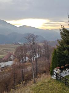a view of a field with mountains in the background at La Baita del Sagittario in Prato Nevoso