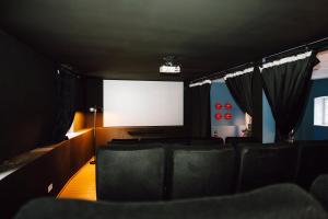a cinema room with chairs and a large screen at Zur alten Oelmuehle Wellness & Entertainment in Ahrhütte