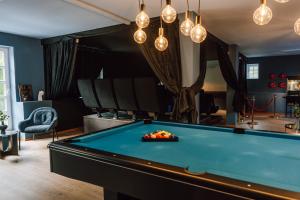 a billiard room with a pool table and chandeliers at Zur alten Oelmuehle Wellness & Entertainment in Ahrhütte +123 photos